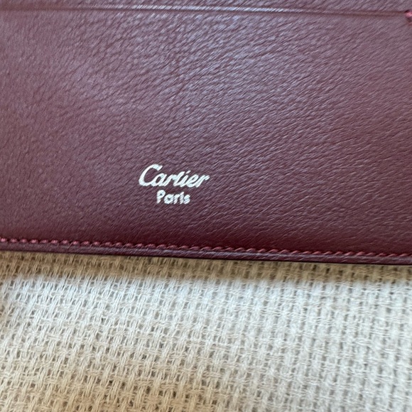 Cartier wallet. NWOT Brown exterior, burgundy interior. Shopping bag included. - Picture 7 of 10